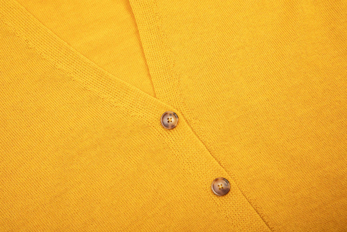 Evolve merino cardigan in golden rod, close up view